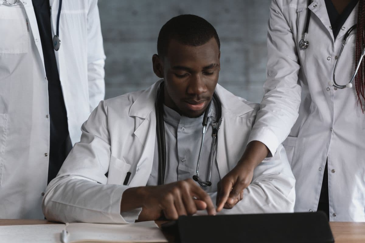 Doctors collaborating on patient records in a clinic